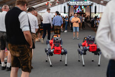 2 Roboter (Ähnlichkeit mit einem Hund) werden den Gästen präsentiert 