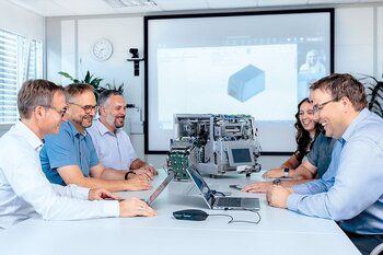 Team bespricht Projektmanagement-Aufgaben in einem Meeting mit Präsentation.