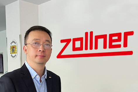 Mitarbeiter aus China steht vor dem Zollner-Logo 